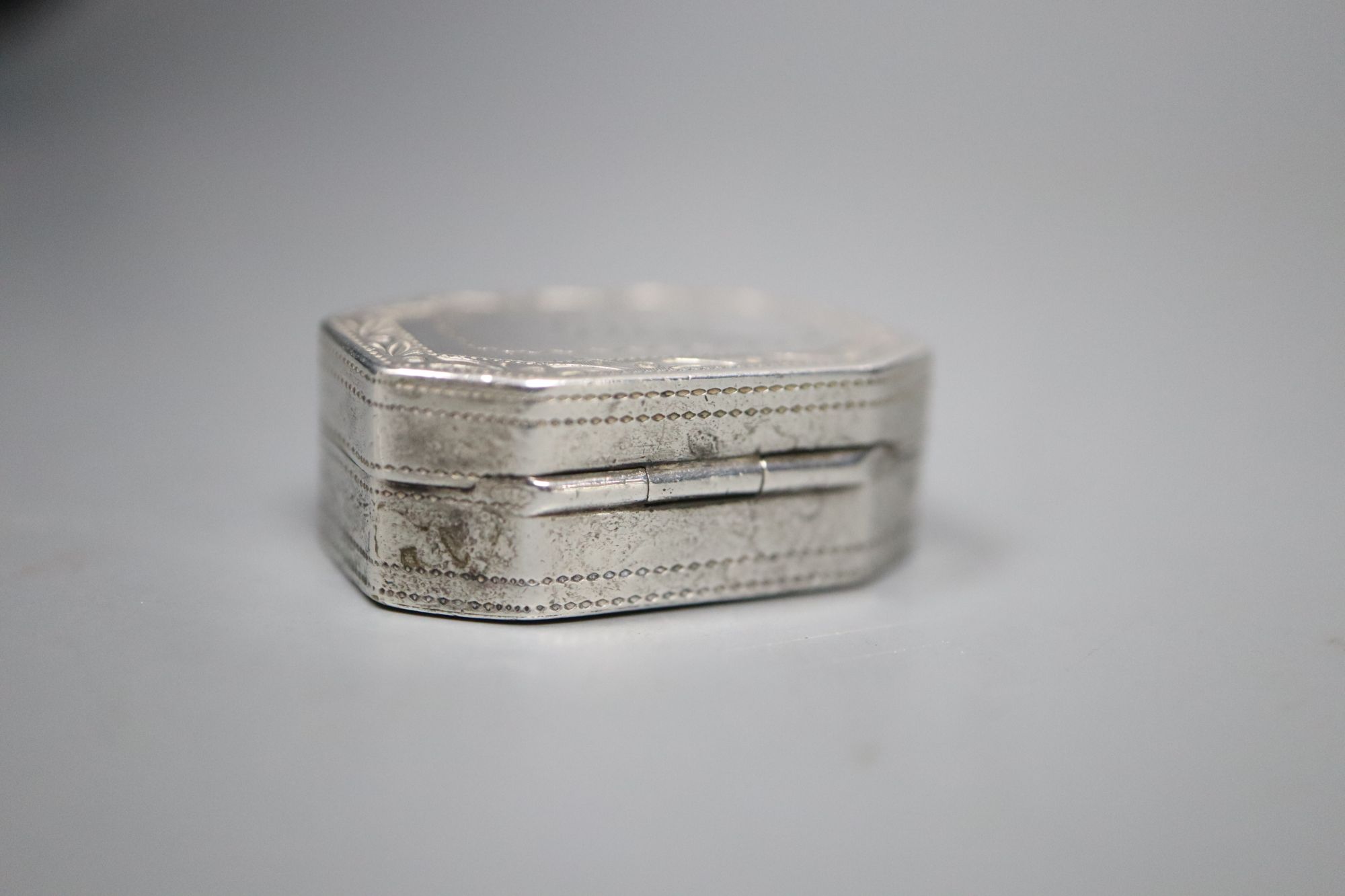 A George III octagonal silver vinaigrette, with bright cut decoration and drilled grille, C & B, Birmingham 1801, 2.75cm